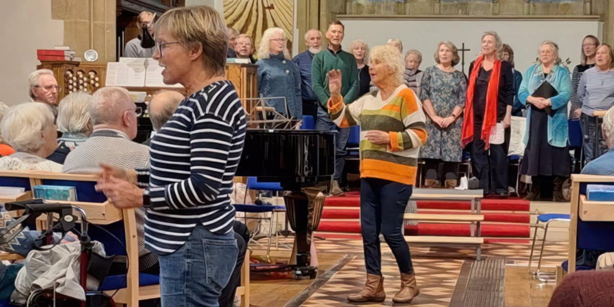 Pam Wedgwood, centre, and Lesley Mariner, conducting the Dementia Friendly choir and the Bay Wailers