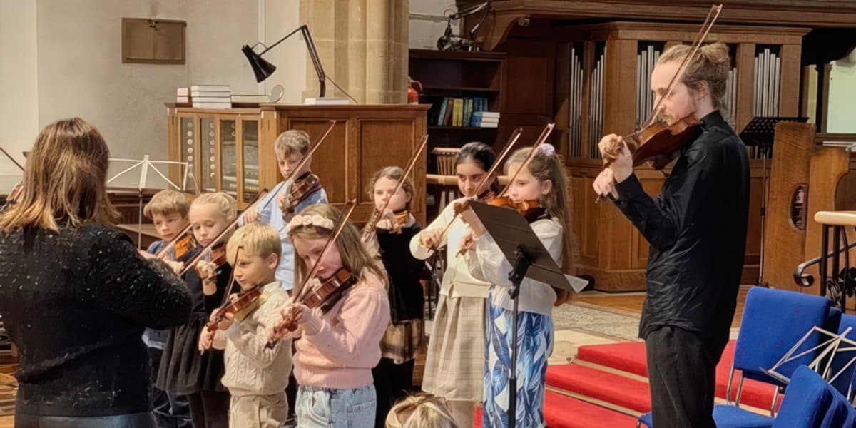 Members of the Suzuki Violin Group playing live