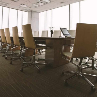 board room table and chairs in sky scraper with floor to ceiling glass windows