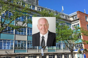 Portrait shot of John Howe with County Hall in the background