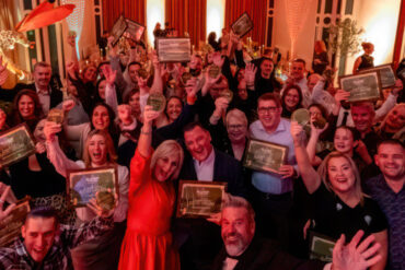 red funnel award winners holding up their awards in Northwood House - nov 2025