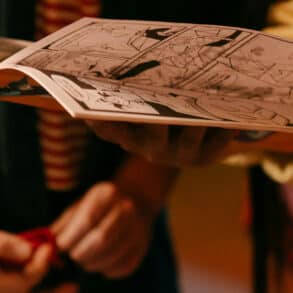 two young people reading a zine