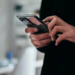 woman looking at her mobile phone with background blurred
