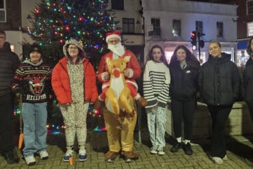 Young people on the walk in Newport with someone dressed as santa
