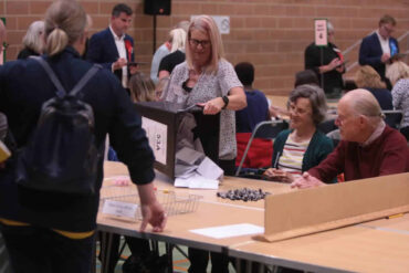Ballot papers being poured out at the election count