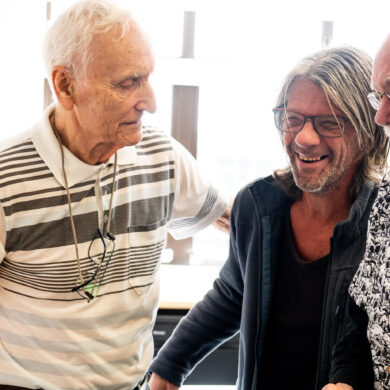 Three men laughing together at the Men's art club