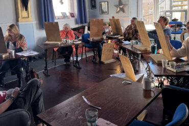 Person modelling for art class in the back of Better Days Cafe
