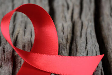 red ribbon on a tree truck