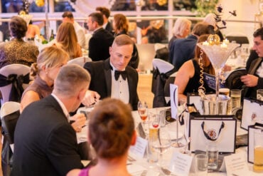 People sat at tables at the charity dinner