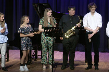 Young musicians standing on the stage