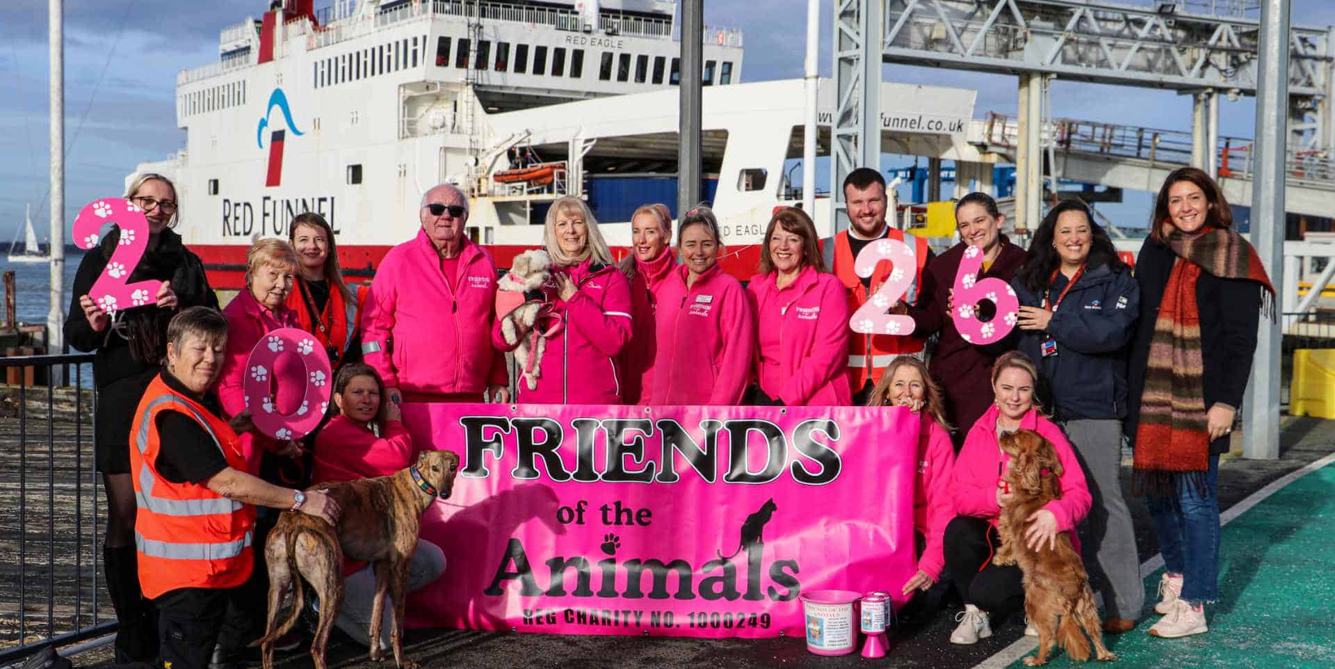Friends of the Animals-team members with Red Funnel staff in front of a ferry