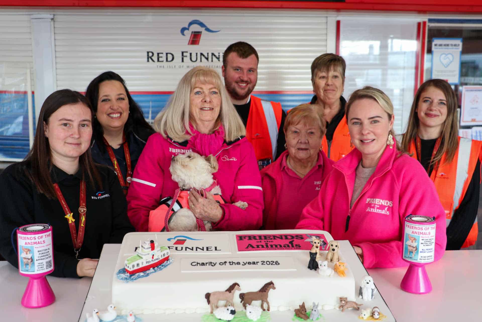 Friends of the Animals-team members with Red Funnel staff standing behind a large celebratory cake
