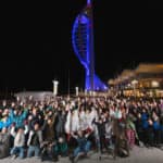 People posing for phot in front of Portsmouth's spinnaker tower