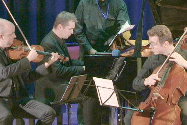 Musicians on stage playing string instruments