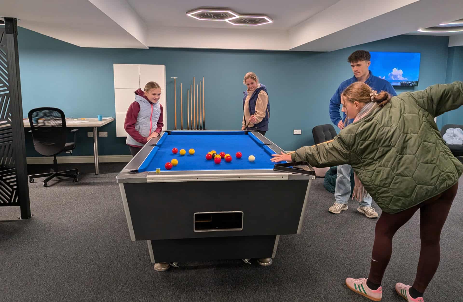 Young people playing pool in Sandown Town Hall