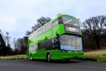 Green bus on country road