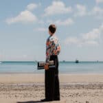 Thomas Luke standing on a beach with an electric keyboard