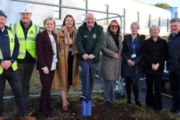 Members of NHS and building staff breaking ground on the site of the extension