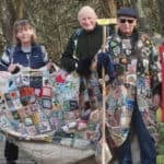 Five people with the Coat of Hopes as it goes on the move