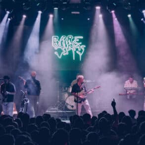 Colour photo of Bare Jams playing on stage
