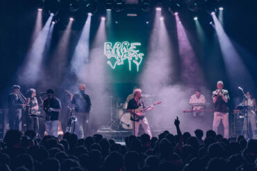 Colour photo of Bare Jams playing on stage