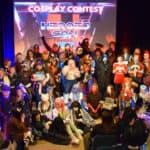 Lots of people on stage dressed in cosplay for the cosplay competition