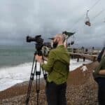 Film crew shooting on the beach at alum bay