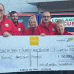 Members of Wight Search and Rescue with a giant cheque from IW Foundation
