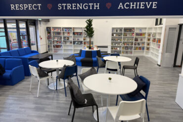 Tables and chairs in the common area at Lionheart School