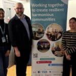 People standing by a safeguarding banner