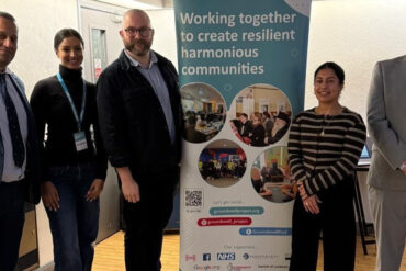 People standing by a safeguarding banner