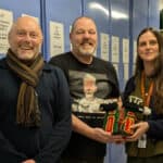 Dave, Josh and Tate staff member with the crocheted item