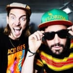 Two male DJs wearing hats and looking into the camera