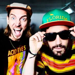 Two male DJs wearing hats and looking into the camera