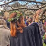 Moonshine Border Morris dancers wassailing around a tree