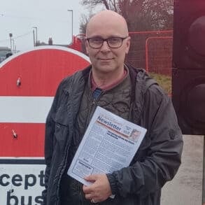 andrew garratt standing by the road closed sign on horsebridge hill