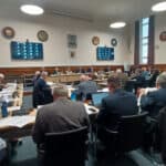 county hall budget meeting showing councillors sitting at desks