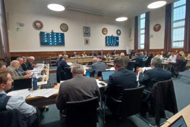 county hall budget meeting showing councillors sitting at desks