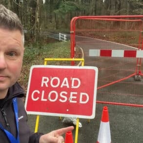 ian dore by closed sign at firestone copse