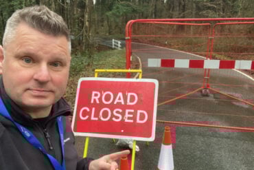 ian dore by closed sign at firestone copse