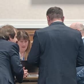 leaders conferring in council meeting