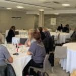 People sitting at round tables during the mountbatten conference 2025