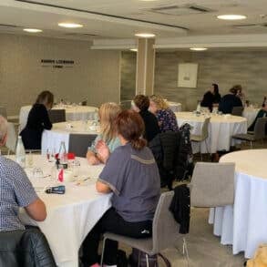 People sitting at round tables during the mountbatten conference 2025