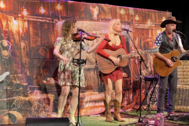 The nashville nights trio performing on stage