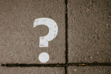 question mark painted on the grey pavement
