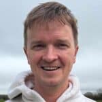 Alan Green smiling at the camera