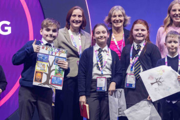 Pupils on stage with Janet Owen at the Bett UK 2026 Award Ceremony