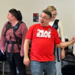 People trying the Deaf Rave Woojar vests
