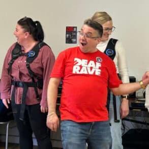 People trying the Deaf Rave Woojar vests