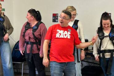 People trying the Deaf Rave Woojar vests